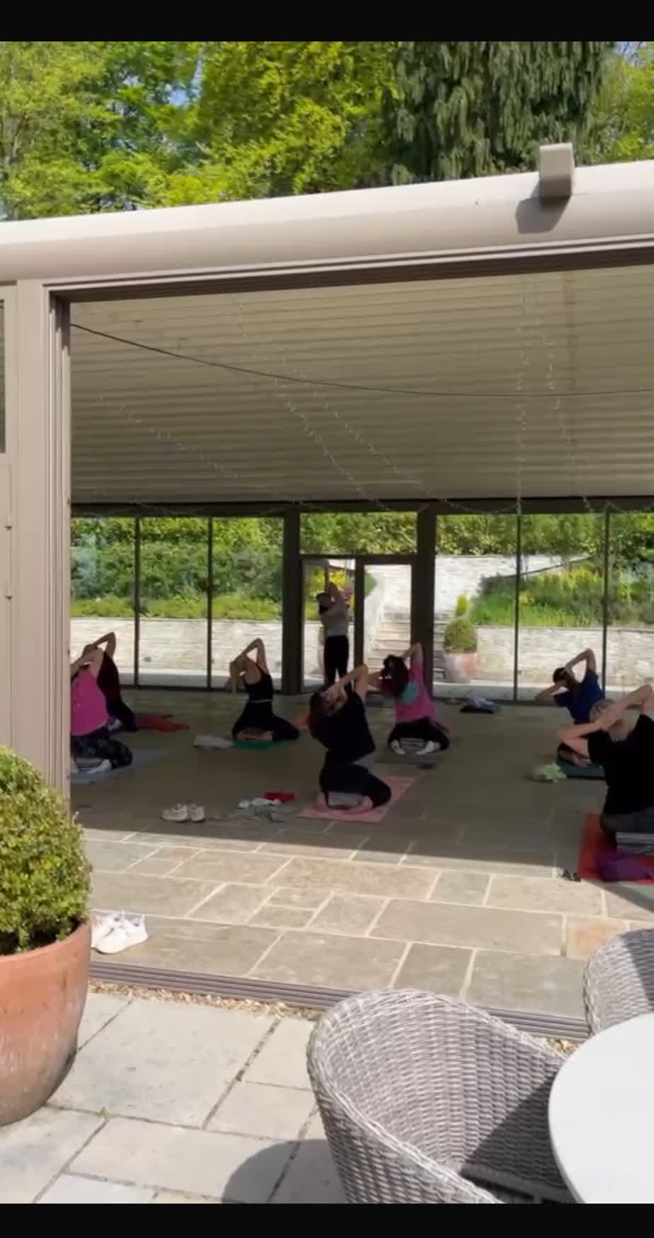 Restorative movement class in the glass-walled garden studio